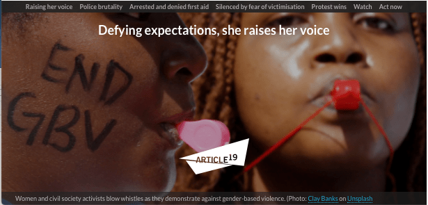 A woman protestor in Kenya is about to blow a red whistle as she faces the camera.